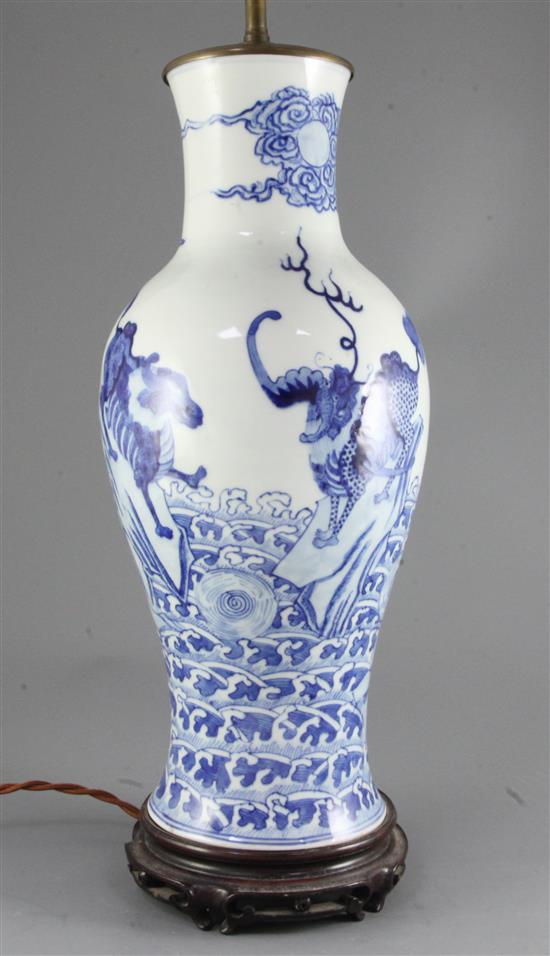 A Chinese blue and white mythical beasts baluster vase, late 19th century/early 20th century, 45cm excluding wood stand and later lam